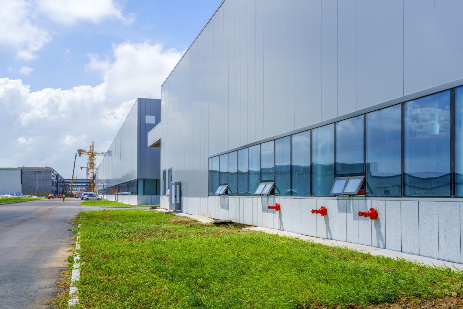 Modern factory and warehouse buildings in a Dubai industrial zone under a blue sky